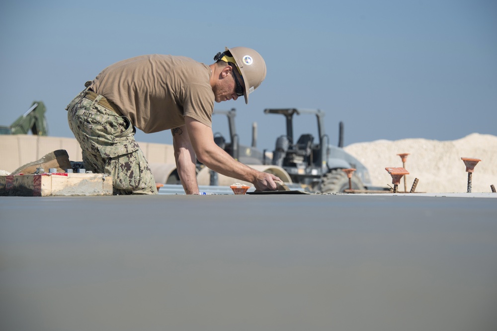 Navy Seabees build concrete pad in Bahrain