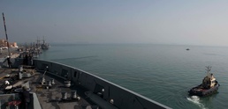 Marines and Sailors aboard the USS Arlington conduct maintenance in Bahrain