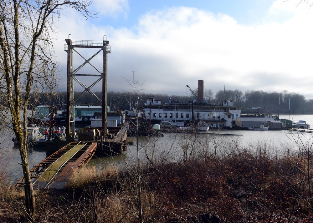Coast Guard oversees removal of hazardous materials off a barge in the Columbia River