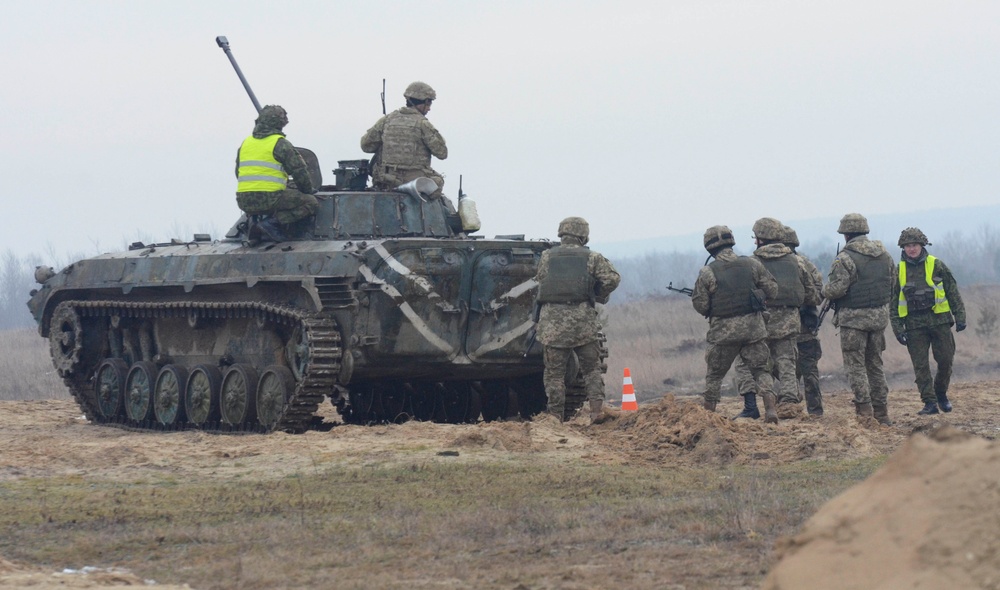 US and Lithuania soldiers instruct Ukrainian soldiers during a live-fire exercise