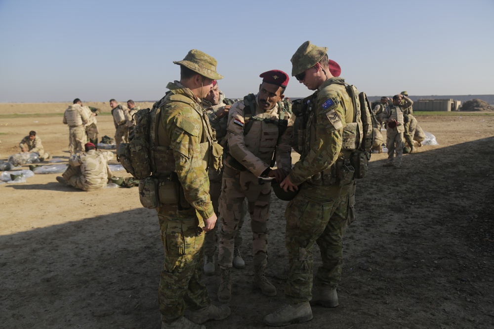 American and Australian forces issue equipment to Iraqi forces