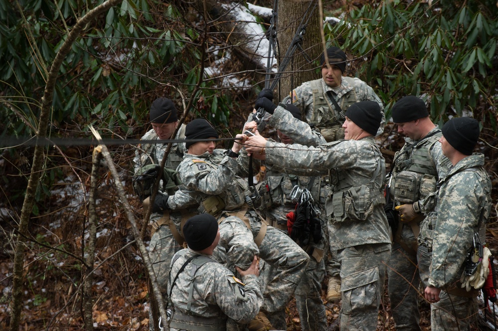 US Army Soldiers prepare to cross rope bridge