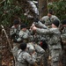 US Army Soldiers prepare to cross rope bridge