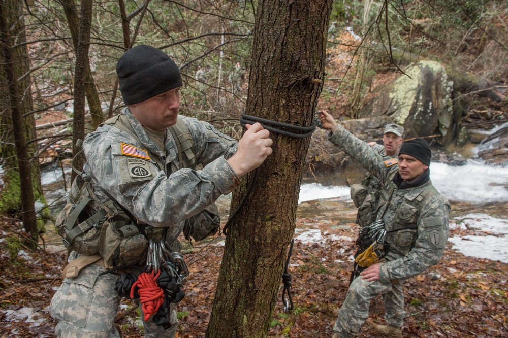 US Army military mountaineering students build rope bridge
