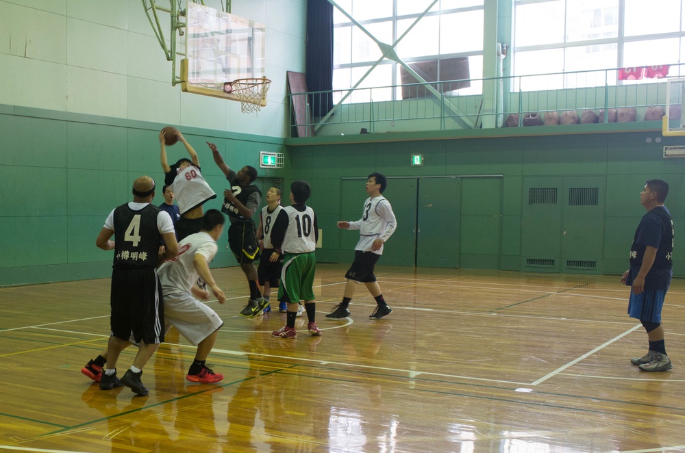 USS Benfold Sailors participate in a COMREL Basketball game with local Otaru high school players