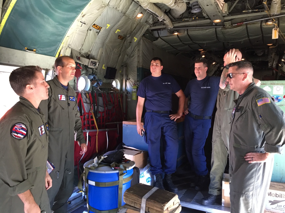 Coast Guard HC-130 Hercules airplane crew conducts pre-flight brief