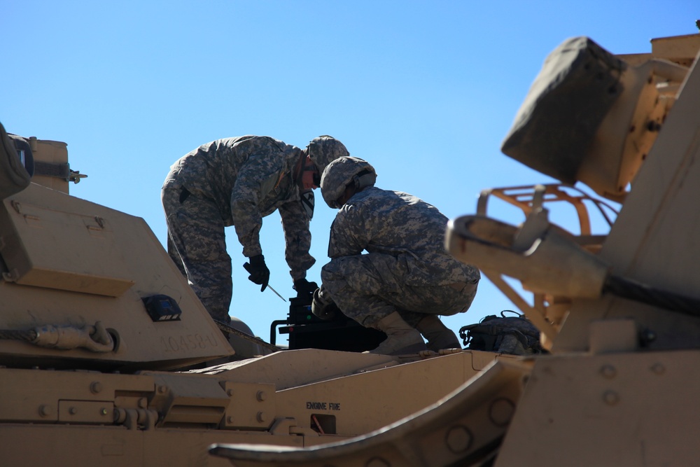 Soldiers conduct maintenance on M1A2 tank