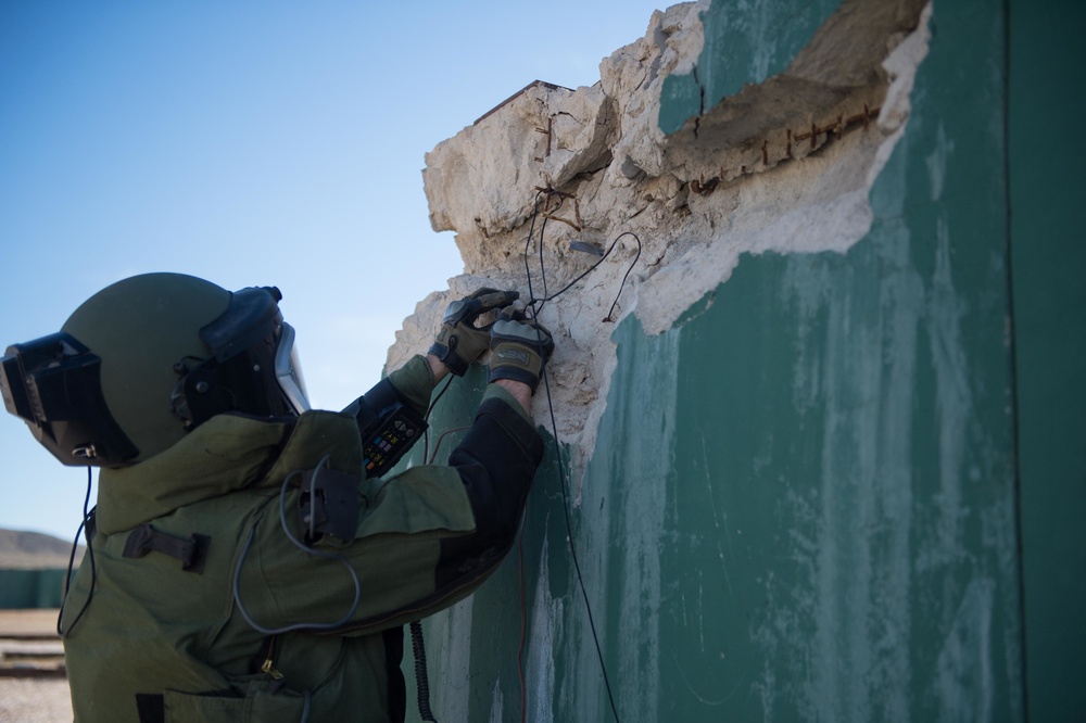 EOD technician seaches for IED