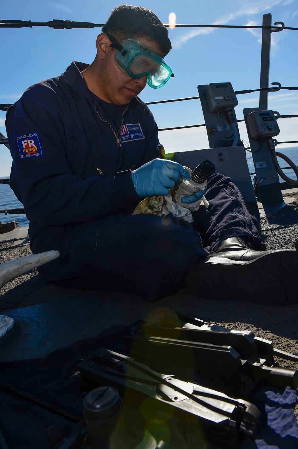 USS Carney sailor cleans machine gun