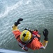 Petty Officer 3rd Class Robert Santoyo descends into the San Francisco Bay
