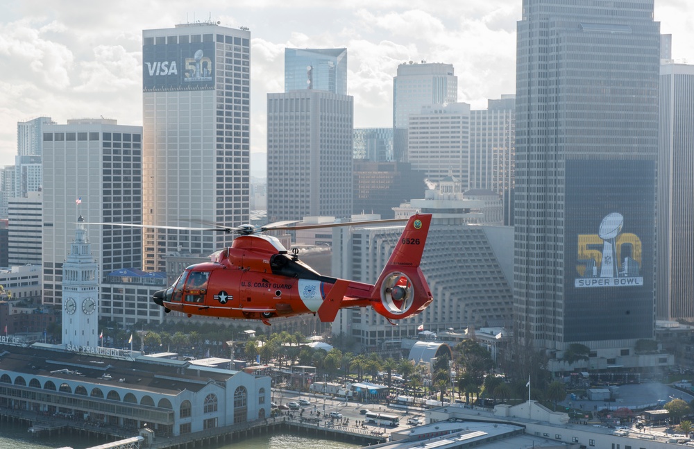 A Coast Guard San Francisco helicopter crew flies near Super Bowl city in San Francisco