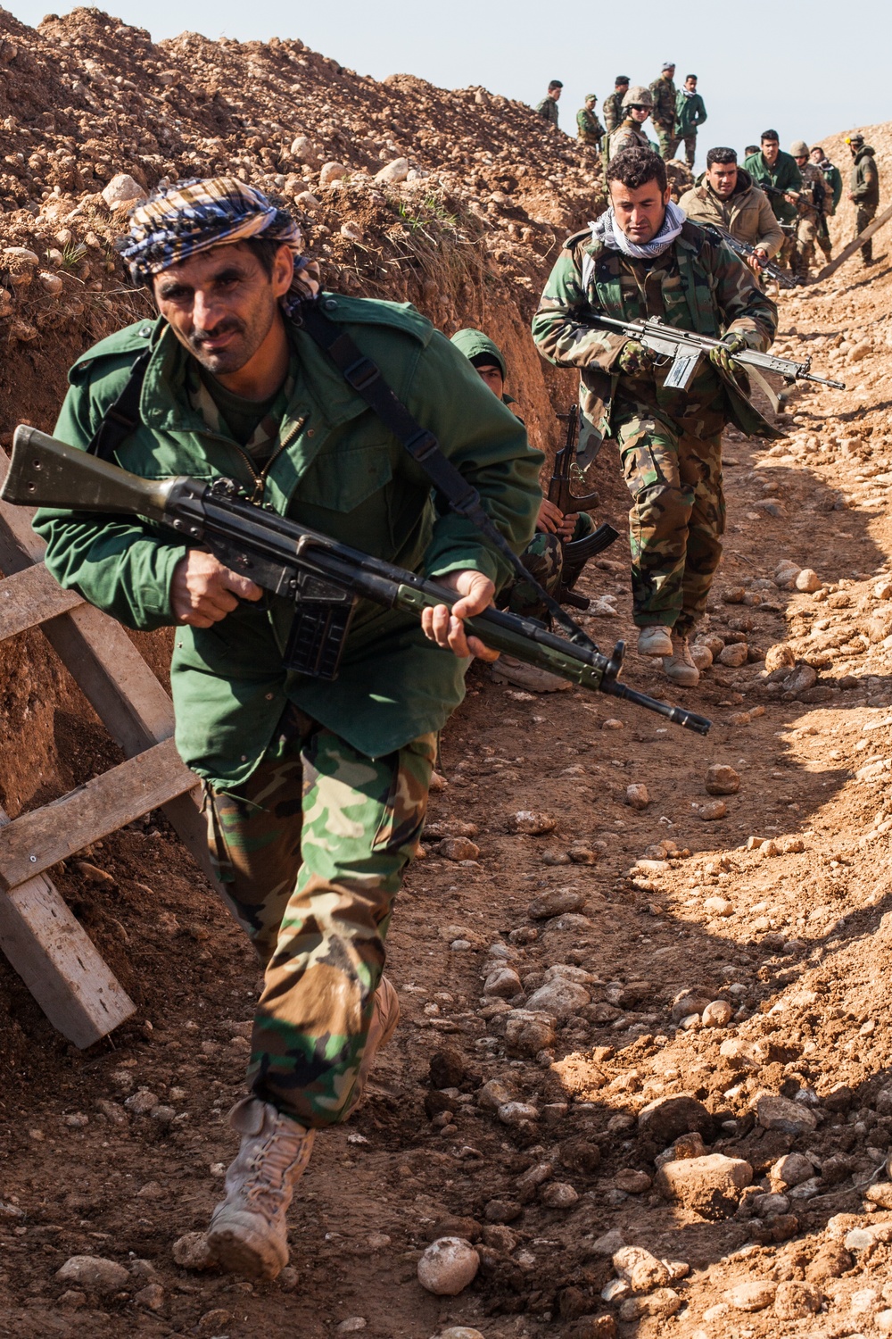 Peshmerga soldiers make fox holes and practice defensive tactical skills under the supervision of German trainers.