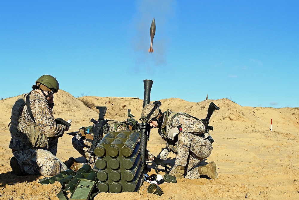 Soldiers of two armies hustle mortars in the sand