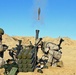 Soldiers of two armies hustle mortars in the sand