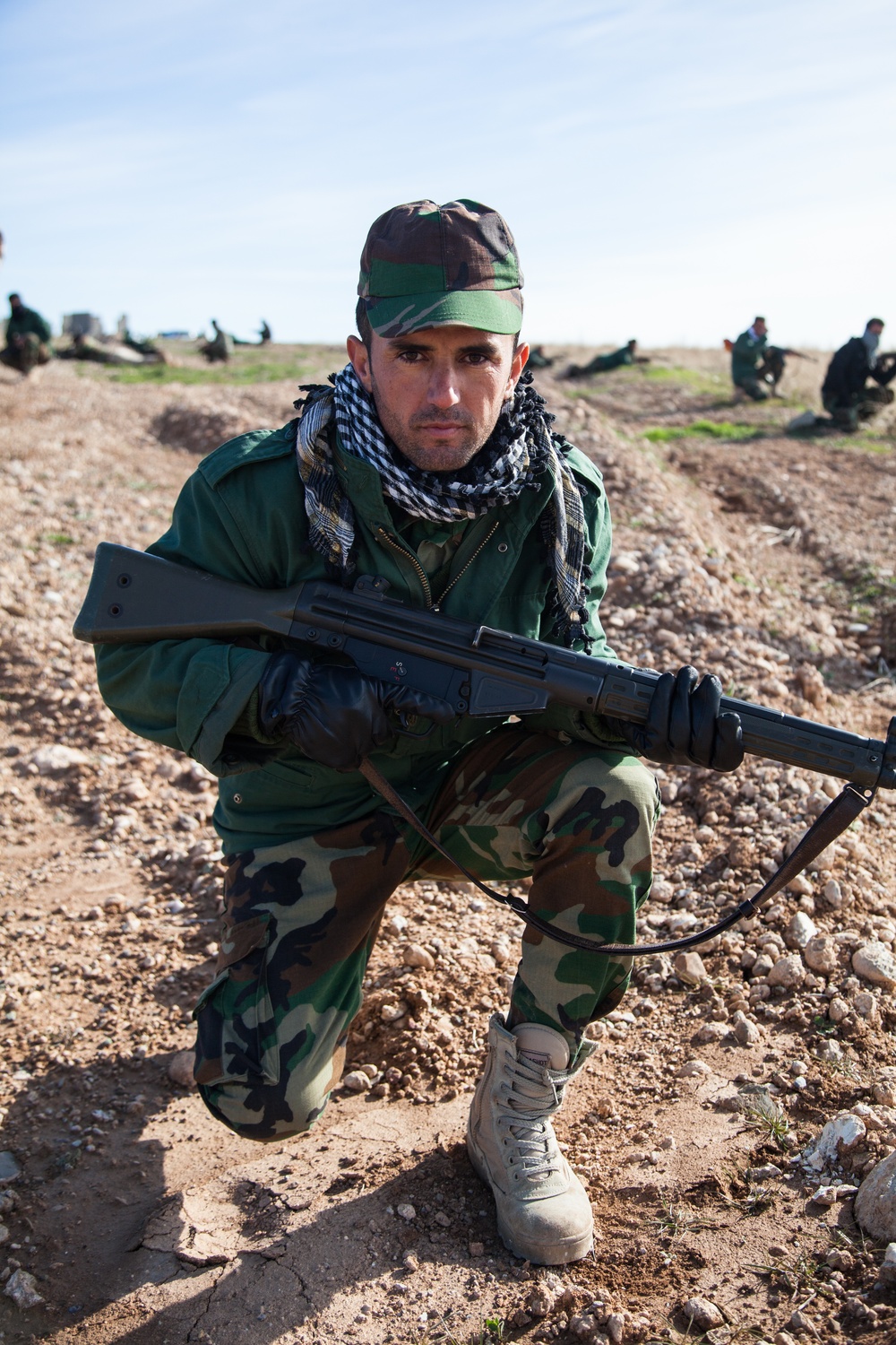Peshmerga soldiers work through their validation assessment under the supervision of German trainers.