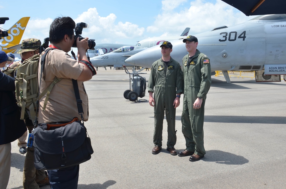 Sailors attached to squadron VP-16 pose for photos during the Singapore International Airshow