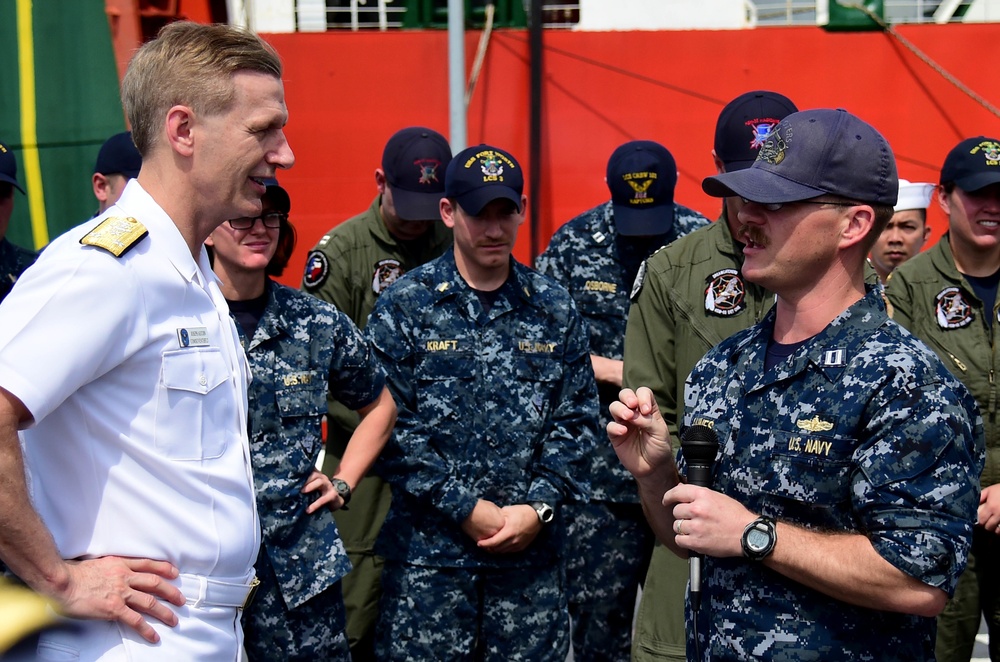 Lt. Geoffrey Gaines, of USS Fort Worth (LCS 3), asks Vice Adm. Joseph P. Aucoin, Commander, US 7th Fleet, a question during an all hands call