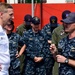 Lt. Geoffrey Gaines, of USS Fort Worth (LCS 3), asks Vice Adm. Joseph P. Aucoin, Commander, US 7th Fleet, a question during an all hands call