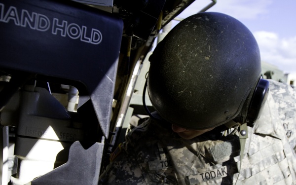 Soldier feeds the 105 mm