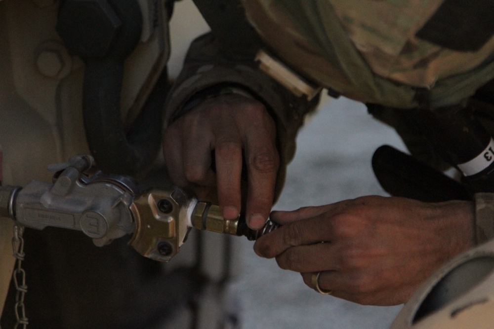 Brave Rifles mechanic fixes vehicle