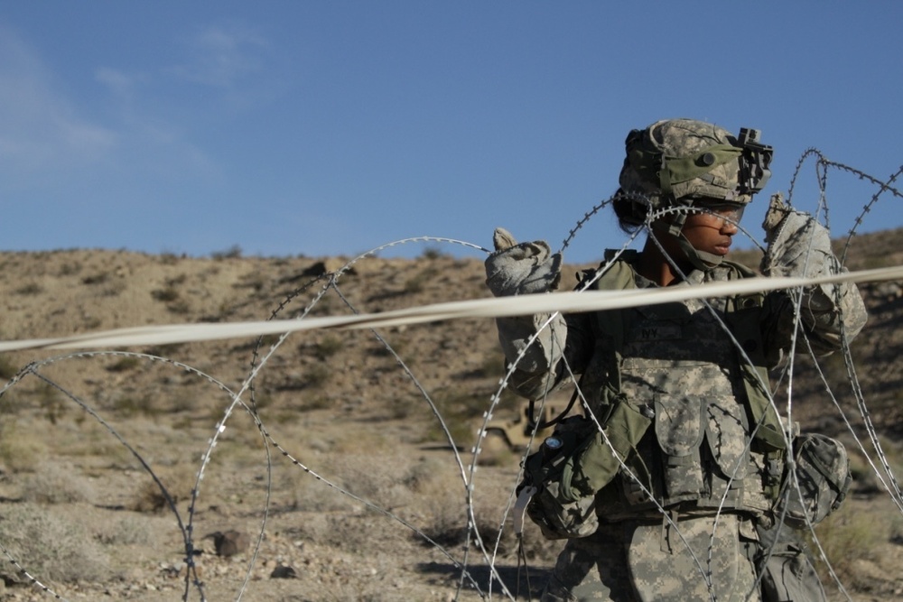 Brave Rifles Soldier sets up concertina wire