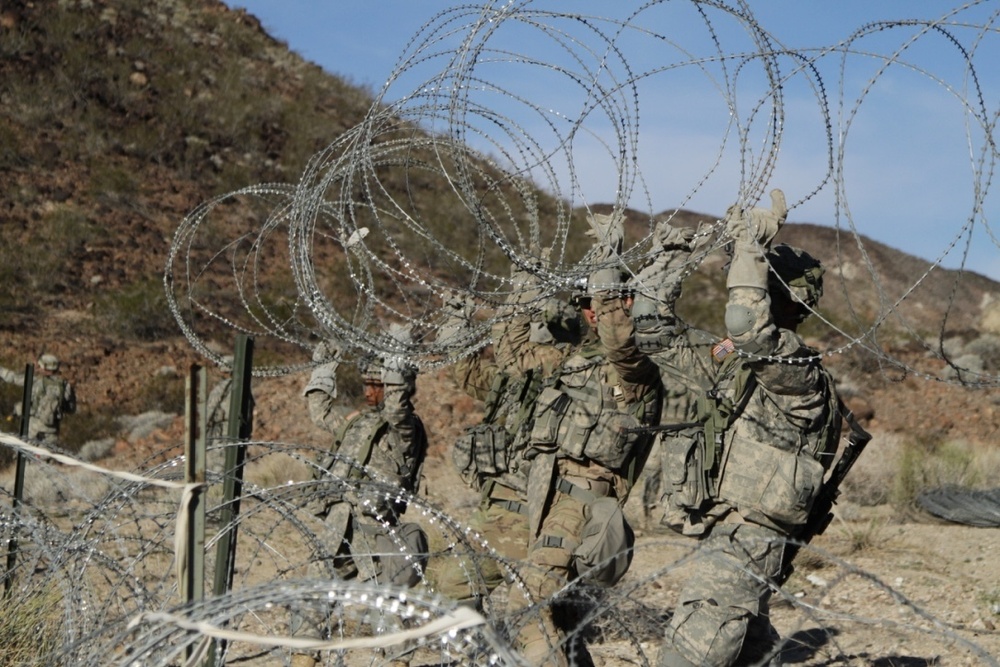 Brave Rifles Soldiers set up concertina wire