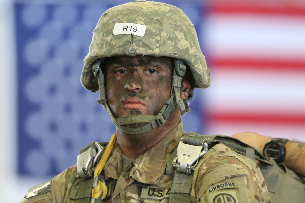 Paratrooper waits to board an aircraft