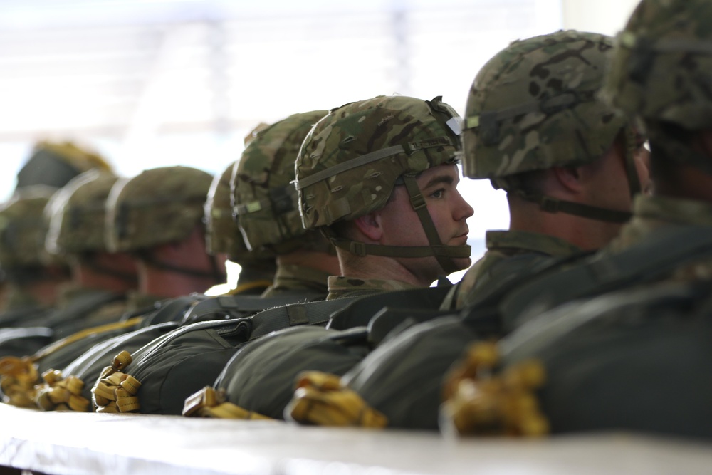 Paratrooper waits to board an aircraft