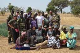 Flintlock participants help women in coastal village