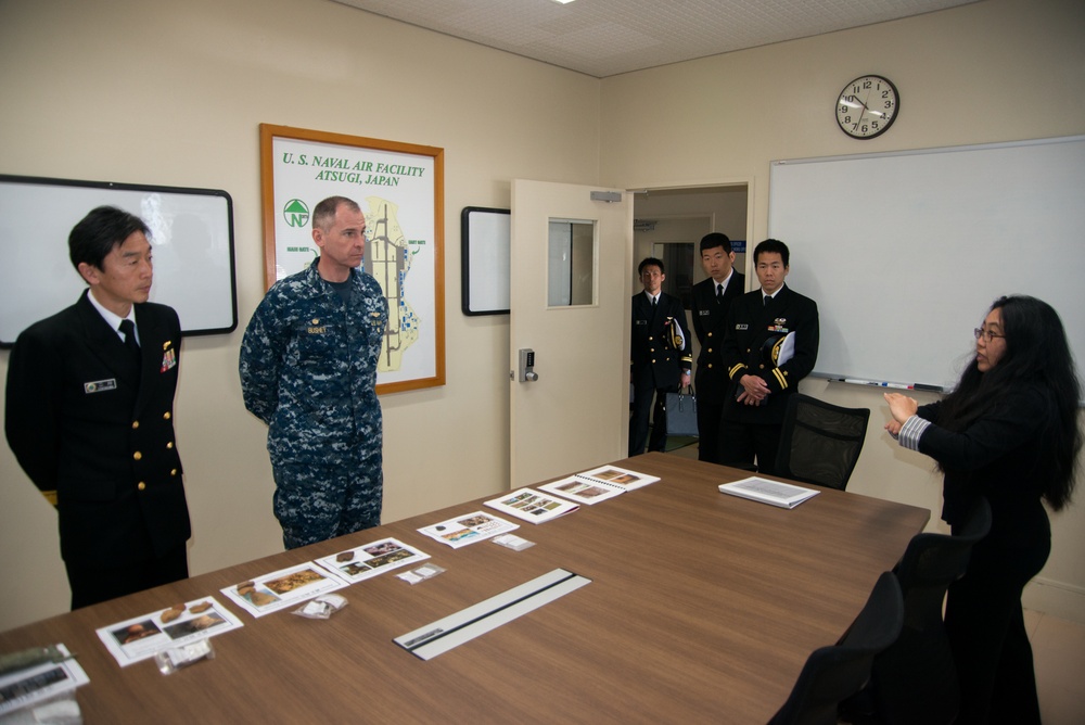 NAF Atsugi CO and JMSDF rear admiral view recovered artifacts