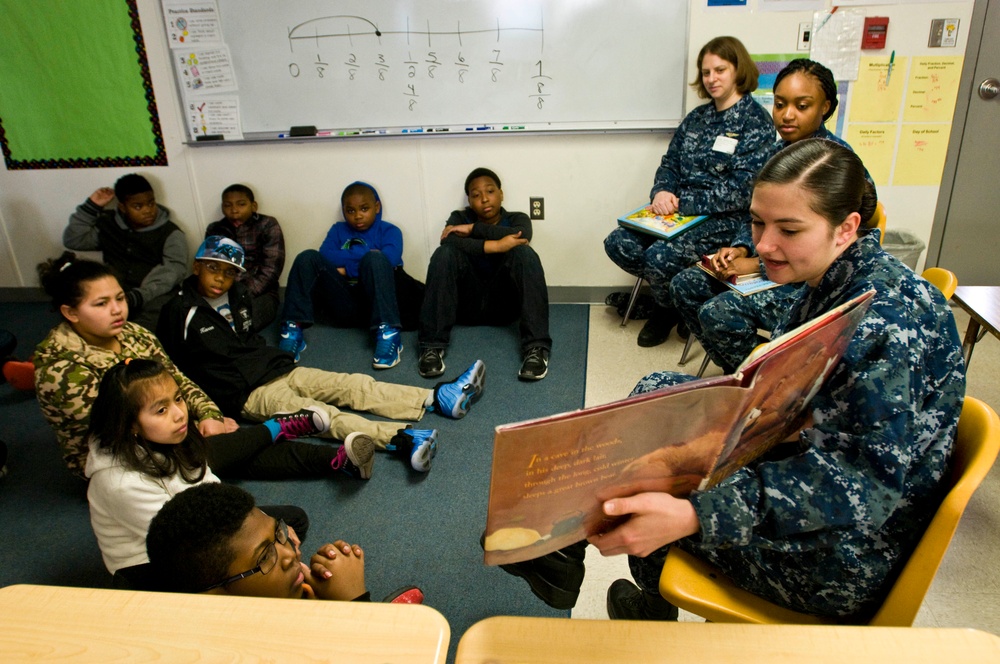 Sailor reads to students at elementary school