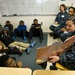 Sailor reads to students at elementary school