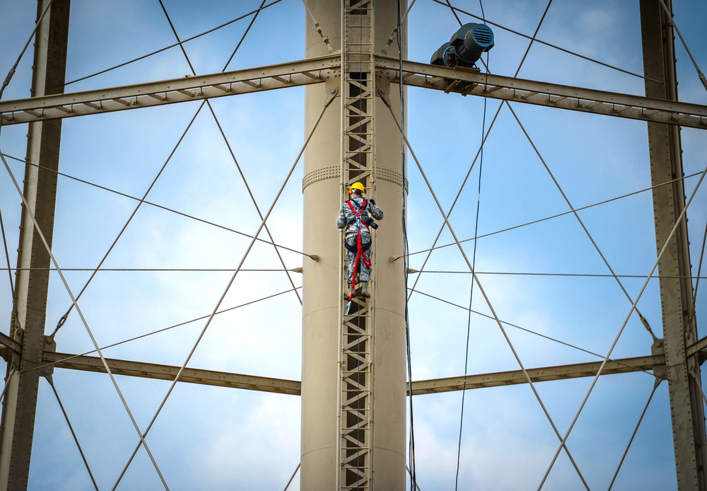 Going up: Airmen climb water tower