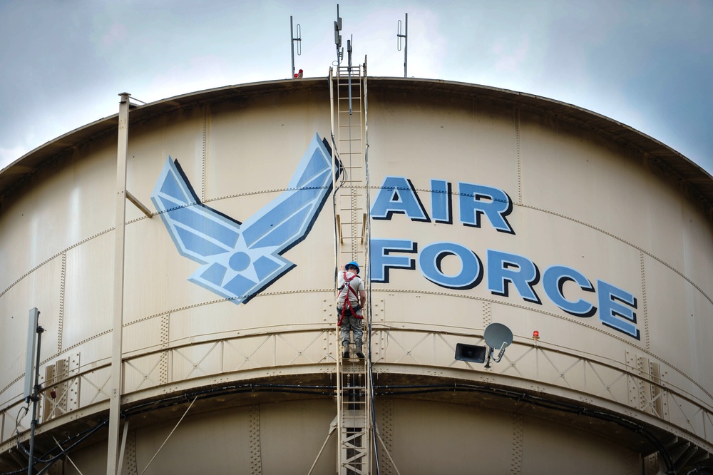 Going up: Airmen climb water tower