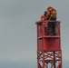 Aids to Navigation Team Woods Hole service lights atop buoys and structures