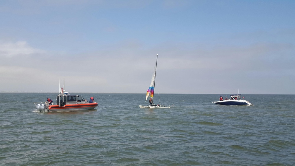 Coast Guard, Coast Guard Auxiliary rescue boater off overturned catamaran near Bolivar Galveston Jetty