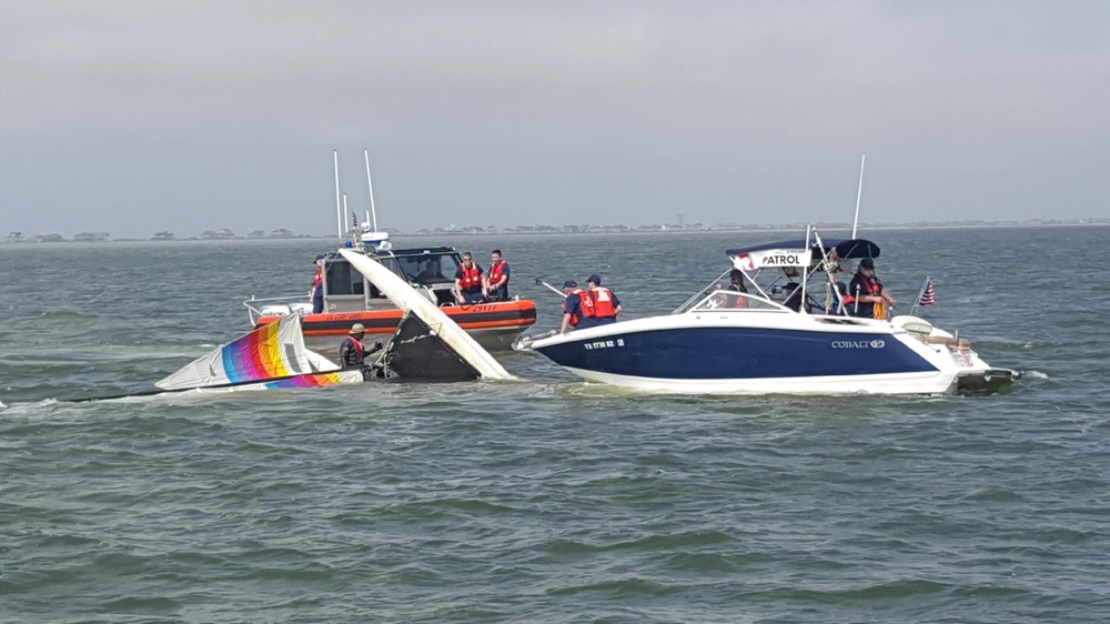 Coast Guard, Coast Guard Auxiliary rescue boater off overturned catamaran near Bolivar Galveston Jetty