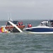 Coast Guard, Coast Guard Auxiliary rescue boater off overturned catamaran near Bolivar Galveston Jetty