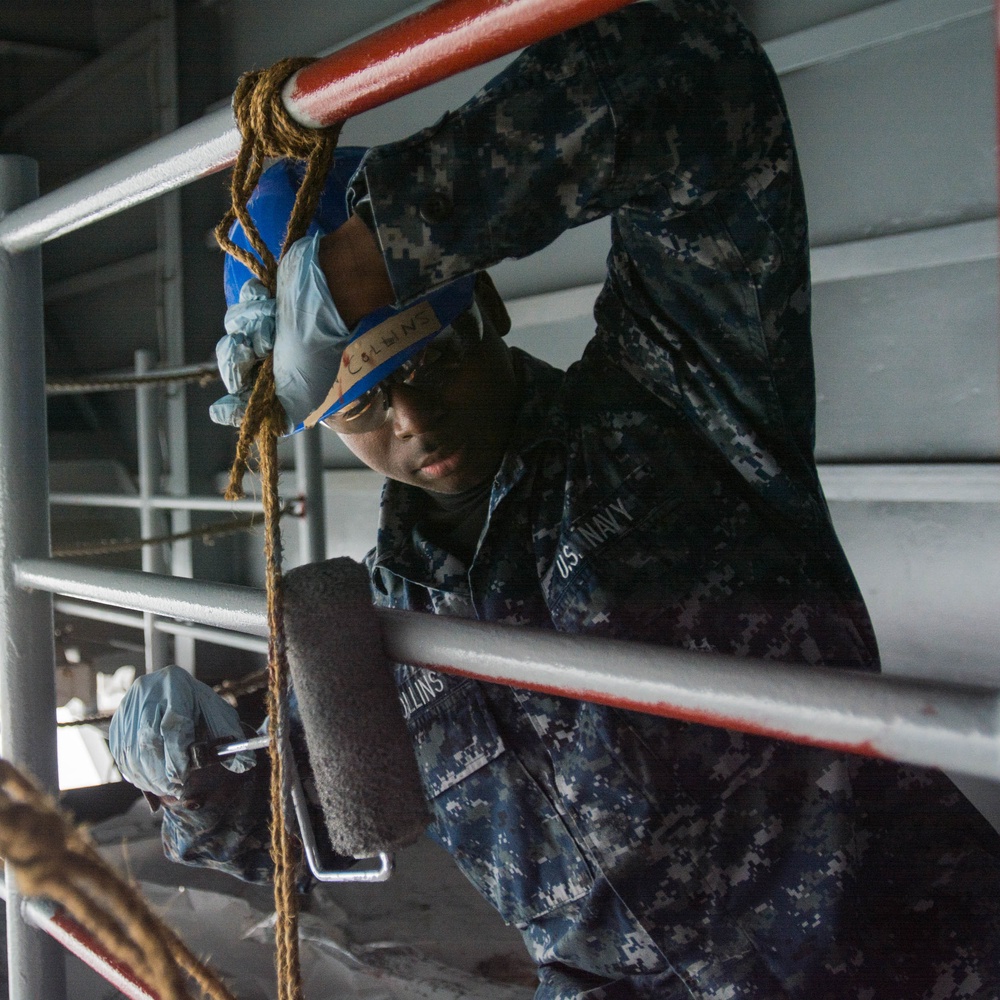 USS Ronald Reagan sailor paints railing