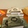 A wooden table displays a collection of military and religious literature distributed by the USARC Chaplain's Office. The materials include Holy Bibles in military camouflage covers (E100 Military Edition), stacks of 'Signs of Life' books, and various pamphlets including 'Mission Ready' and 'Resiliency' booklets. This appears to be a resource or information table, likely at a military installation or chaplain's event.
