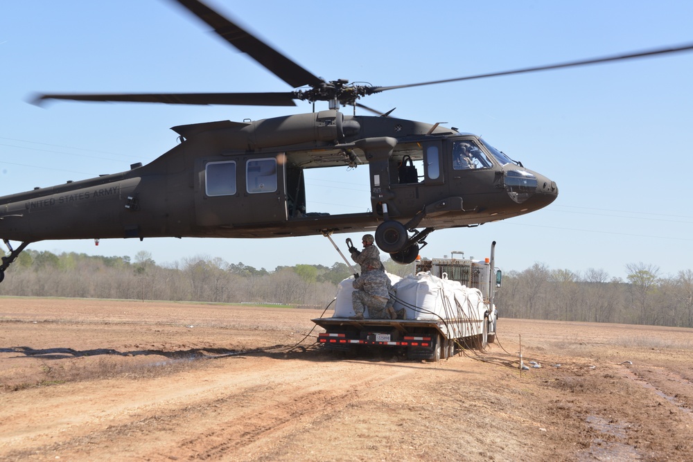 La. Guardsmen sling-load super sacks into failed control structure