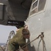 U.S. Marines with VMM 162 (REIN) wash down aircraft