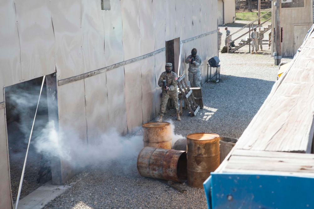 U.S. Army Soldier moves through paintball course