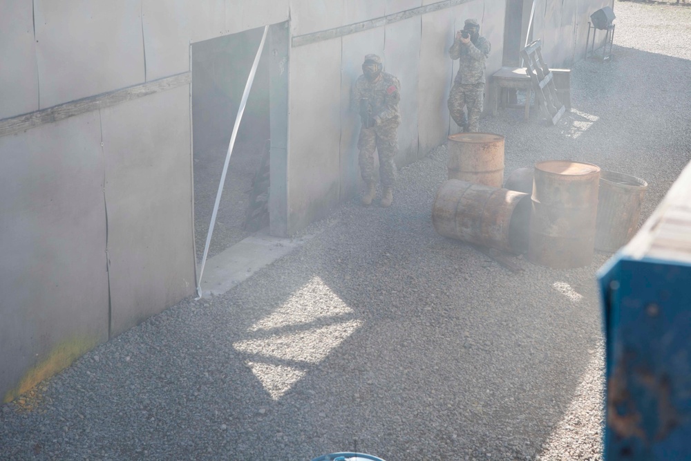 U.S. Army Soldier moves through paintball course