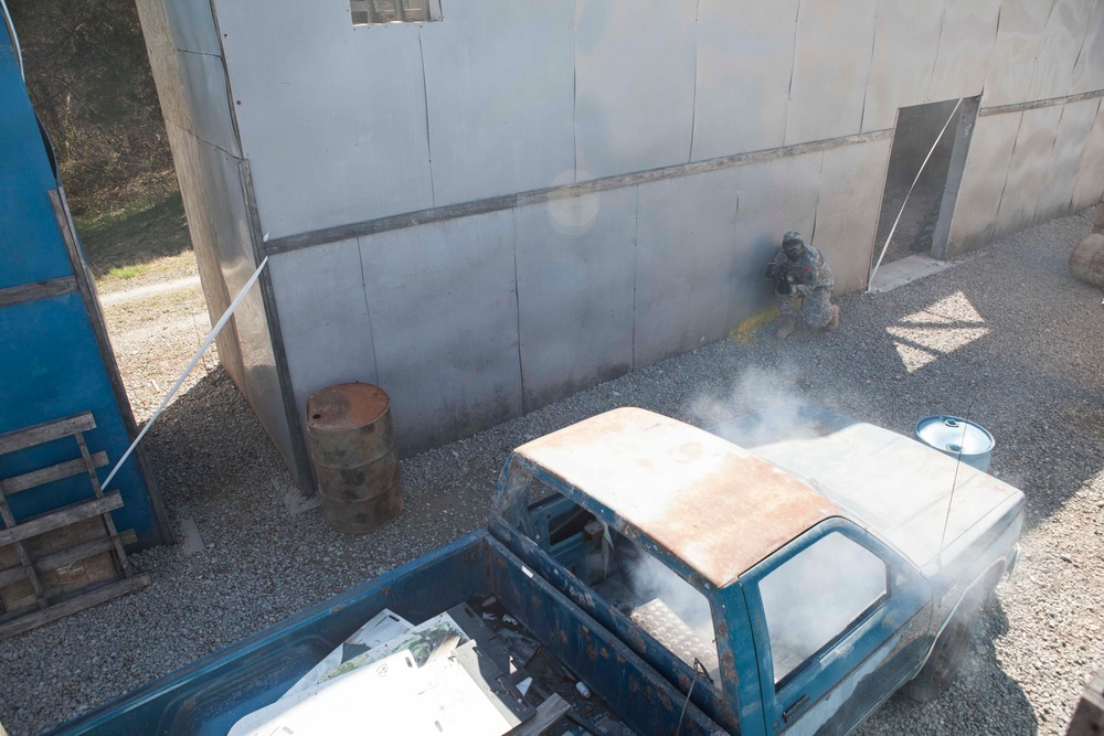 U.S. Army Soldier moves through paintball course