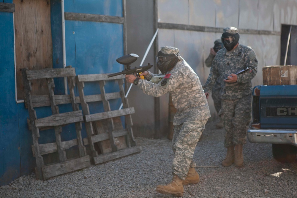 U.S. Army Soldier moves through paintball course