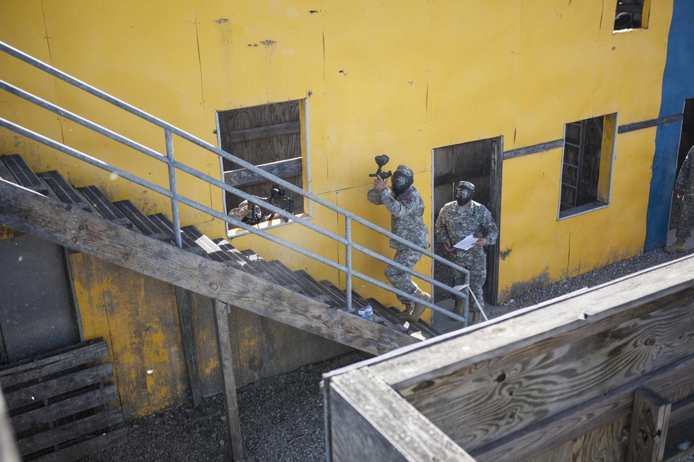 U.S. Army Soldier moves through paintball course