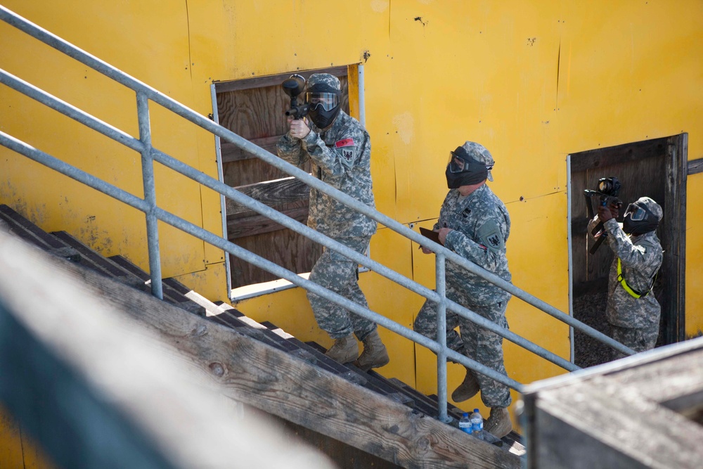 U.S. Army Soldier moves through paintball course