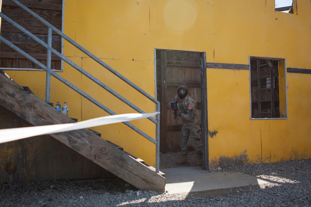 U.S. Army Soldier moves through paintball course