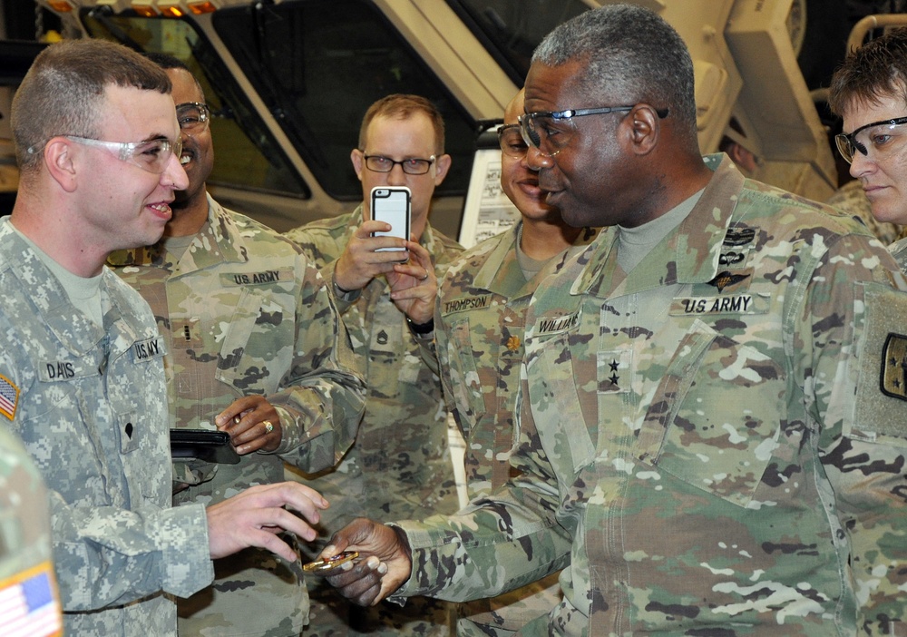 Receiving a coin from the CASCOM Commander while trianing at the Iowa National Guard Sustainment Trianing Center